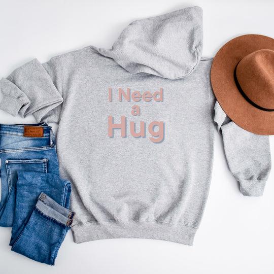 I Need a Hug Hoodie – Cozy Pullover for Comfort and Emotional Expression